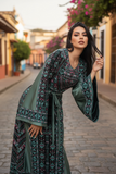 Elegant & Bold Emerald Palestinian Thoub glow amidst city colors.