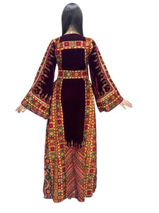 Maroon velvet Palestinian embroidered traditional long thobe with matching headpiece.