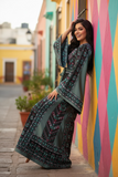 Elegant & Bold Emerald Palestinian Thoub glow amidst city colors.