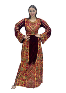 Maroon velvet Palestinian embroidered traditional long thobe with matching headpiece.