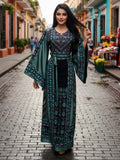 Elegant & Bold Emerald Palestinian Thoub glow amidst city colors.