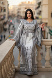 White Elegant & Bold Palestinian Thoub glow amidst city colors.
