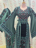 Elegant & Bold Emerald Palestinian Thoub glow amidst city colors.