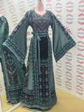 Elegant & Bold Emerald Palestinian Thoub glow amidst city colors.
